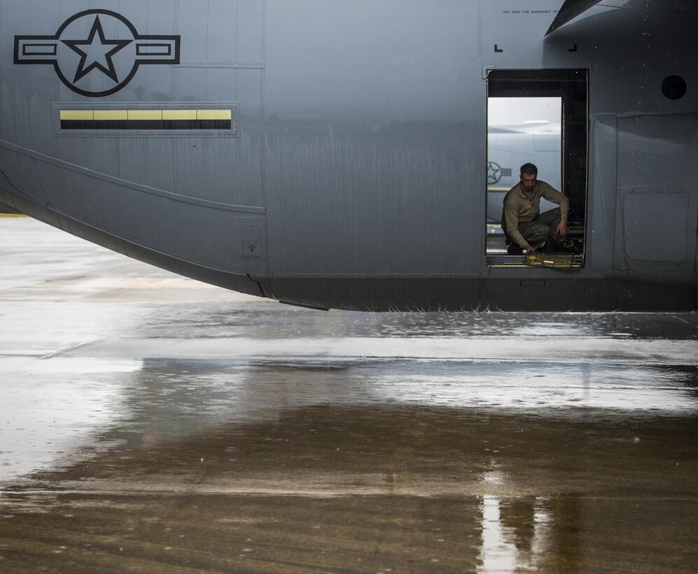 Air Force Senior Airman Nick Warner conducts pre-flight maintenance on a C-130J Super Hercules aircraft on Pope Army Airfield, N.C., Feb. 4, 2016. Warner is a crew chief assigned to the 19th Aircraft Maintenance Squadron. Air Force photo by Staff Sgt. Marianique Santos