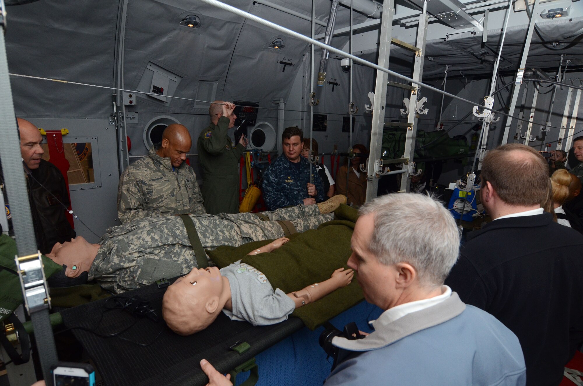 Maj. Chad Corliss, Director of Operations from the 94th Aeromedical Evacuation Squadron briefs members of the Honorary Commanders Association on the functions of a newly installed aeromedical evacuation training simulator. The system is designed to simulate various emergency conditions experienced by medical personnel during evacuation scenarios. The demonstration was part of Dobbins Day, a base tour conducted on Dobbins Air Reserve Base, Ga. Feb. 12, 2016 (U.S. Air Force photo/Don Peek)