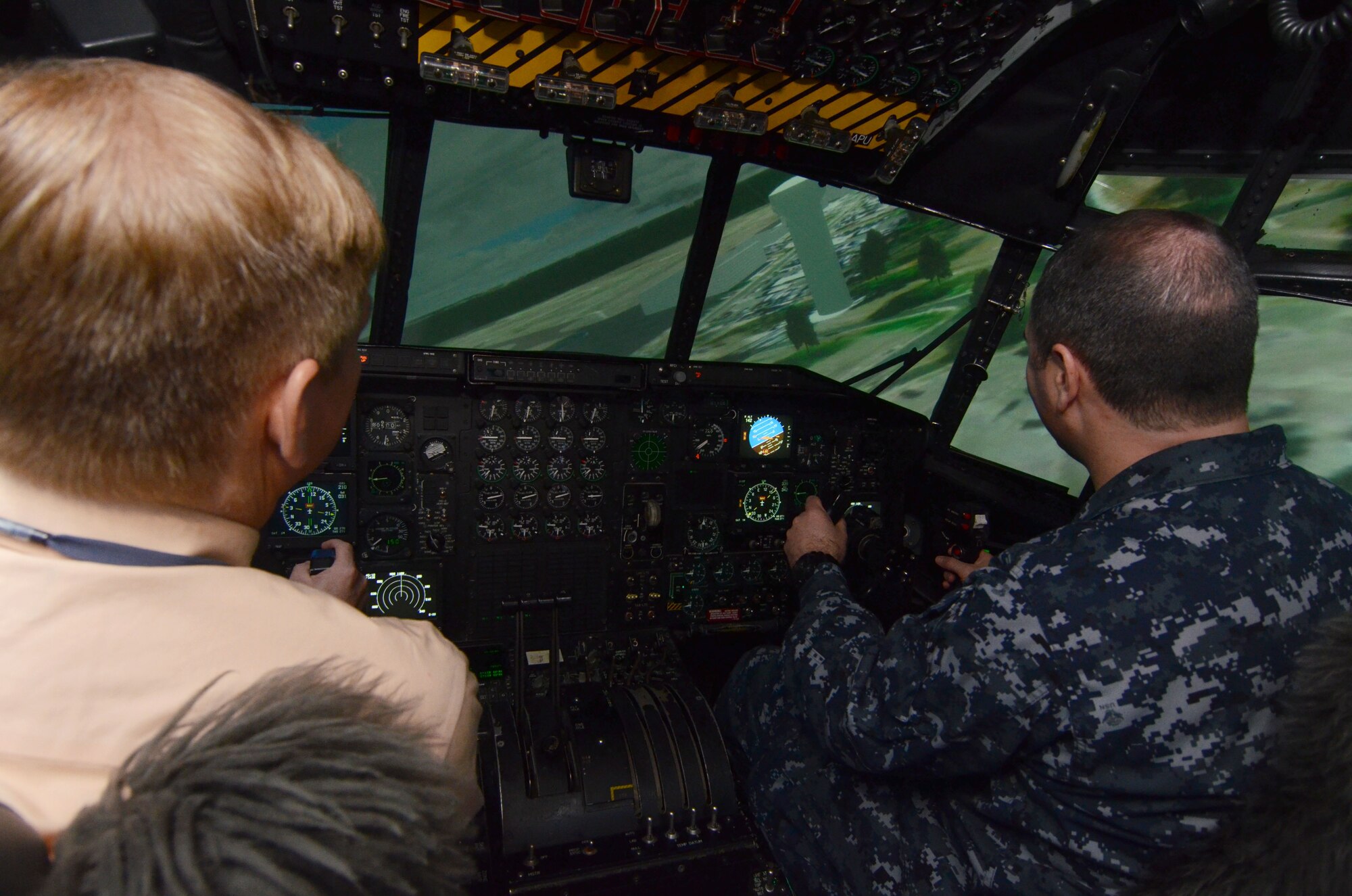 Members of the Honorary Commanders Association receive hands –on experience while getting the opportunity to fly a C-130 flight simulator during Dobbins Day, while touring Dobbins Air Reserve Base, Ga. Feb. 12, 2016. (U.S. Air Force photo/Don Peek)