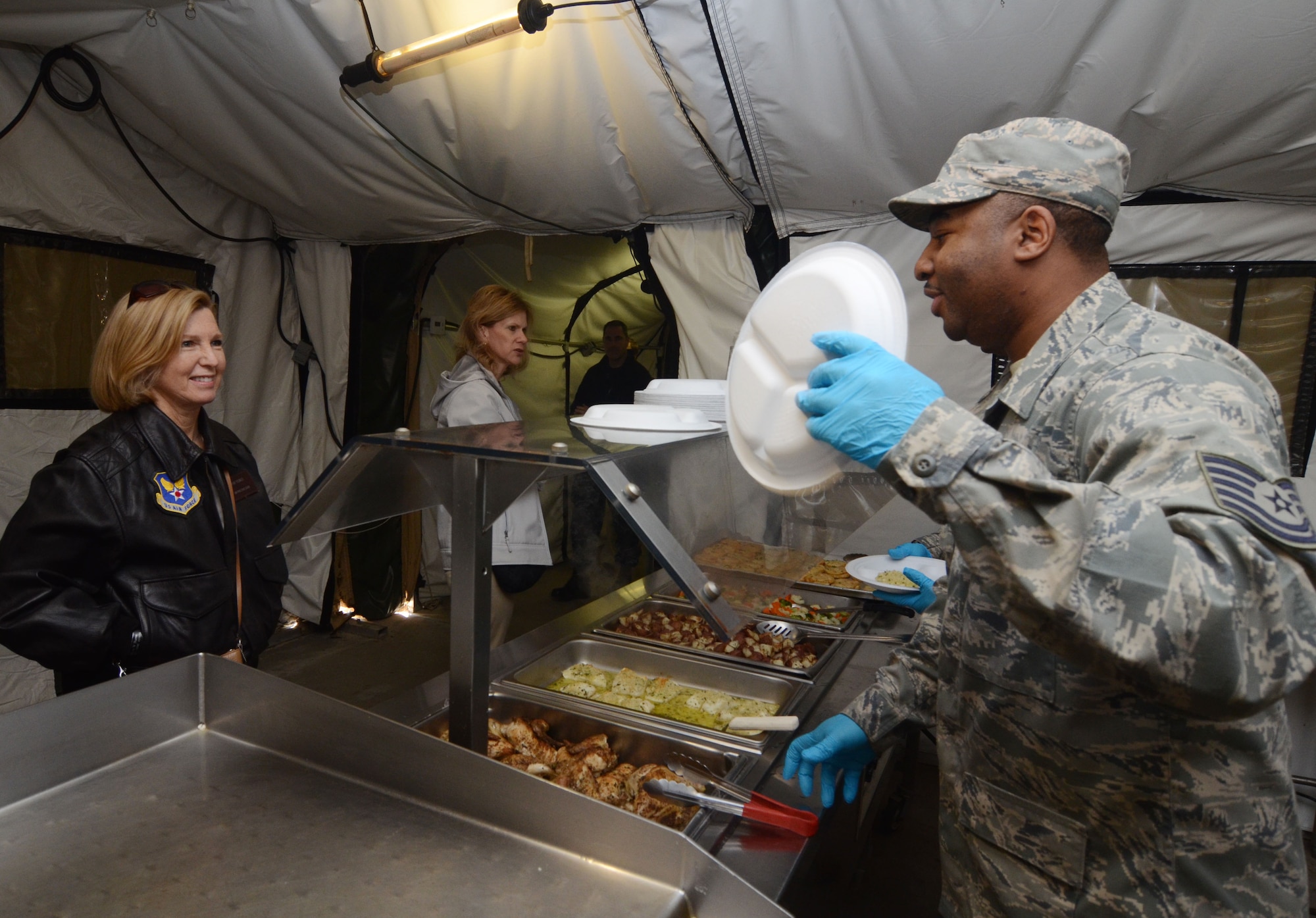 Members of the Honorary Commanders Association experience lunch in a field kitchen dining facility during Dobbins Day, while touring Dobbins Air Reserve Base, Ga. Feb. 12, 2016. (U.S. Air Force photo/Don Peek)