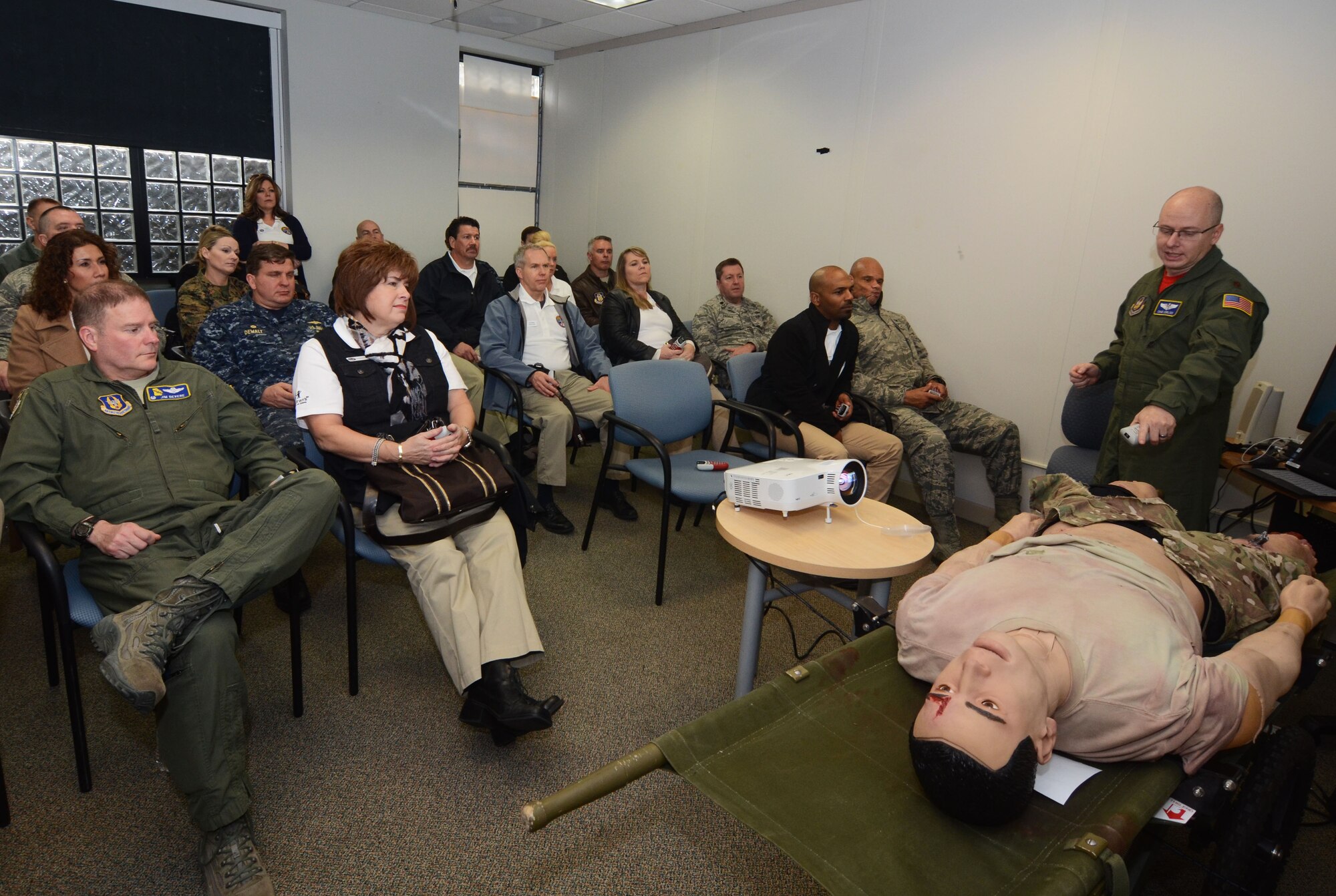 Maj. Chad Corliss, Director of Operations from the 94th Aeromedical Evacuation Squadron, briefs members of the Honorary Commanders Association on various experiences encountered by medical personnel during critical emergency evacuations. The demonstration was part of Dobbins Day, a base tour conducted on Dobbins Air Reserve Base, Ga. Feb. 12, 2016. (U.S. Air Force photo/Don Peek)