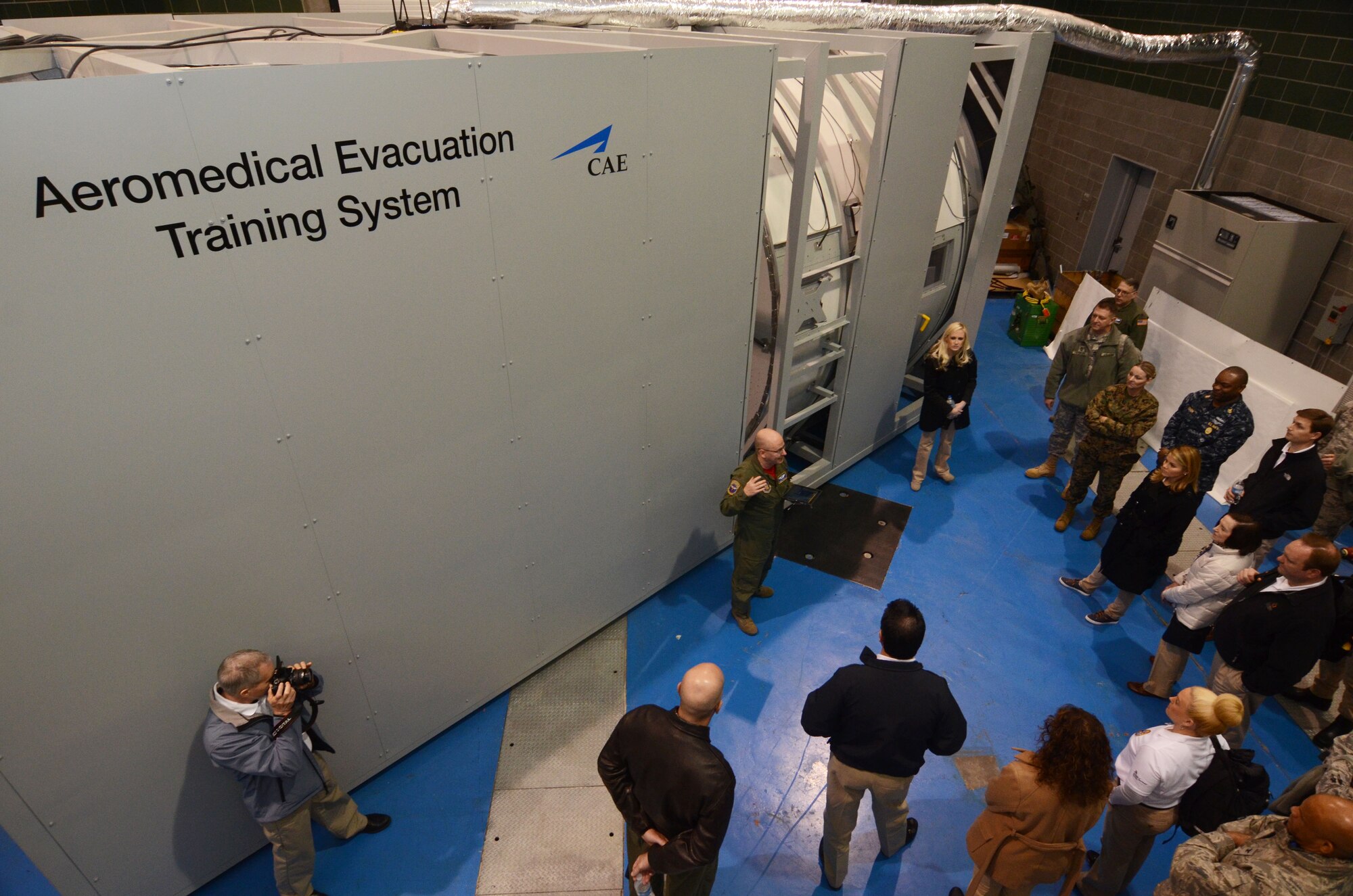 Maj. Chad Corliss, Director of Operations from the 94th Aeromedical Evacuation Squadron, briefs members of the Honorary Commanders Association on the functions of a newly installed aeromedical evacuation training simulator. The system is designed to simulate various emergency conditions experienced by medical personnel during evacuation scenarios. The demonstration was part of Dobbins Day, a base tour conducted on Dobbins Air Reserve Base, Ga. Feb. 12, 2016 (U.S. Air Force photo/Don Peek)