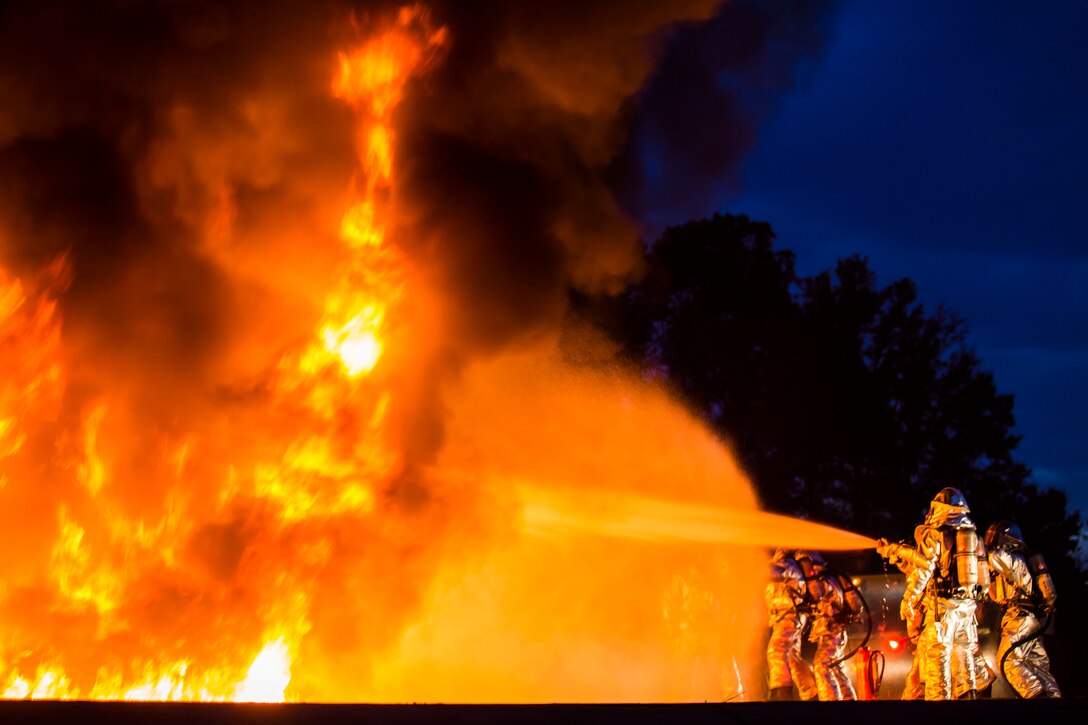 Marines extinguish a fire during a controlled burn training exercise aboard Marine Corps Air Station Beaufort Feb. 17. The Marines battling the blaze use hoses to push the fire away from the model jet’s cockpit to simulate procedure for rescuing the pilot in a real life scenario. The Marines are with Aircraft Rescue and Firefighting. (U.S. Marine Corps Photo by Lance Cpl. Jonah Lovy/Released)