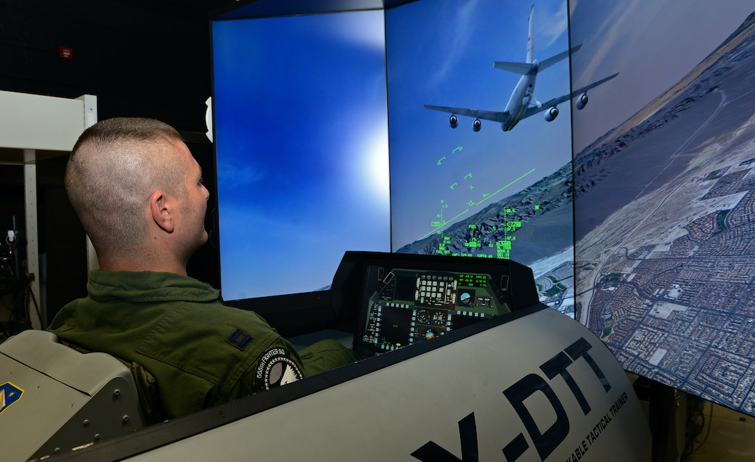 Capt. Matthew Sabraw, 555th Fighter Squadron F-16 Fighting Falcon pilot, operates an F-16 simulator, Dec. 12, 2013, at Aviano Air Base, Italy. Pilots adhere to a strict training program tailored to Aviano’s mission of deter aggression, defend U.S. and NATO interests, and develop Aviano. (U.S. Air Force photo by Senior Airman Matthew Lotz/Released)