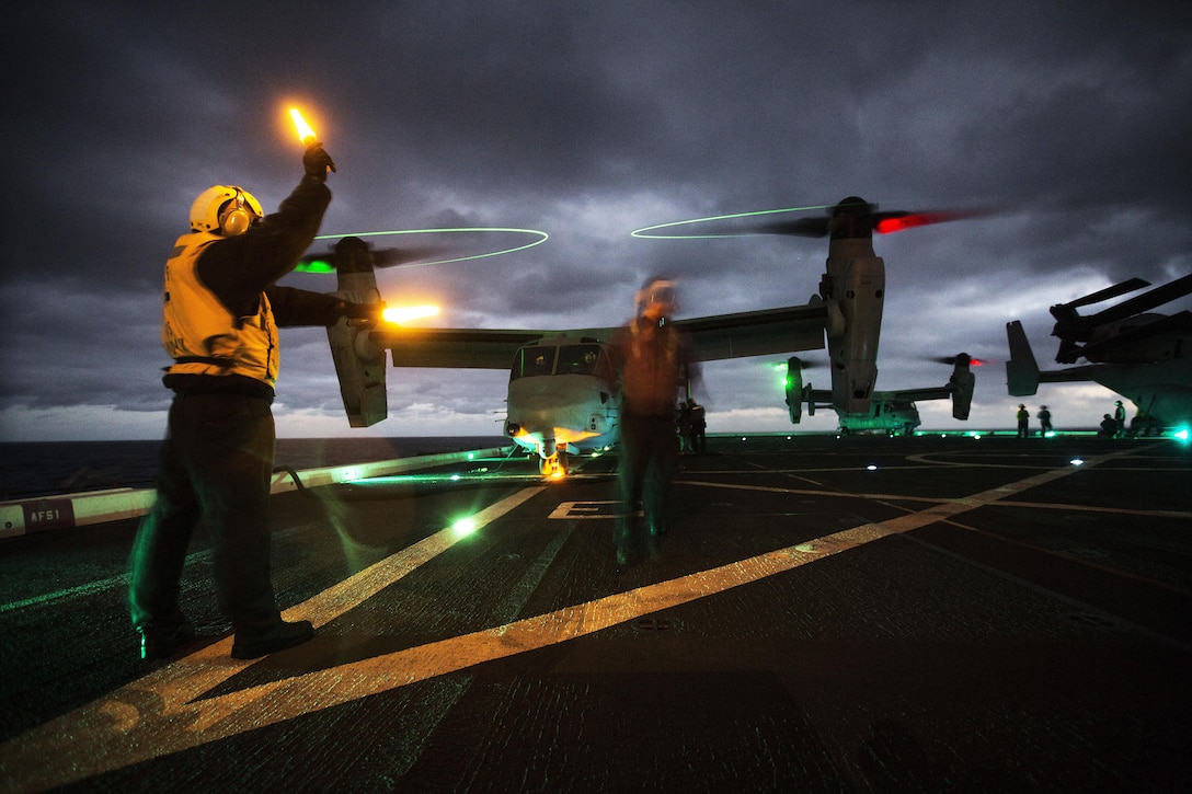 Sailors prepare MV-22B Ospreys for takeoff aboard the USS New Orleans in the Pacific Ocean, Feb.16, 2016. The Ospreys are assigned to Marine Medium Tiltrotor Squadron 166. Marine Corps photo by Sgt. Tyler C. Gregory