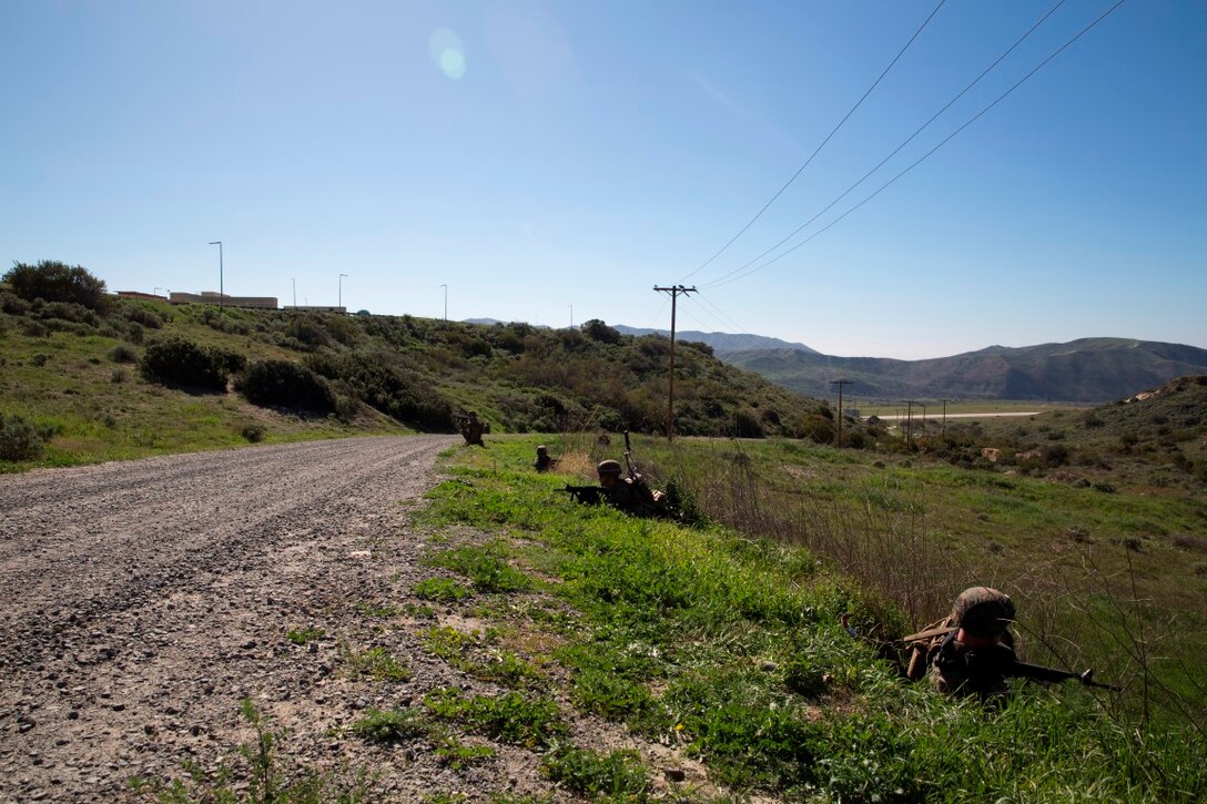 Marines set security while waiting for Explosive Ordnance Disposal technicians during counter-IED training at Camp Pendleton, Feb. 12, 2016. This is a new C-IED training curriculum developed by Marine Corps Engineer School, Defeat the Device Branch. The Marines conducting the training are with Company A, 1st Combat Engineer Battalion, 1st Marine Division.