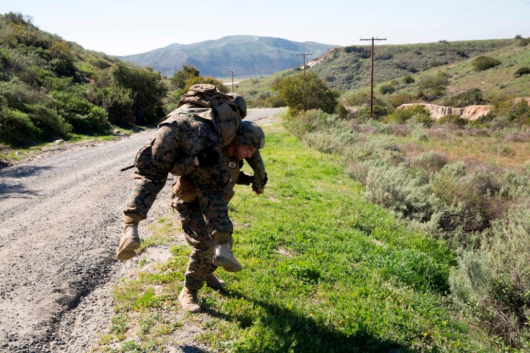 Lance Cpl. Brandon Larue carries Cpl. Estelito Manansala a notional casualty during a counter-IED training exercise at Camp Pendleton, Feb. 12, 2016. This training is a part of a new Counter-IED Training Class developed by the Marine Corps Engineer School, Defeat the Device Branch, to improve operational readiness. Larue and Manansala are with Company A., 1st Combat Engineer Battalion, 1st Marine Division.