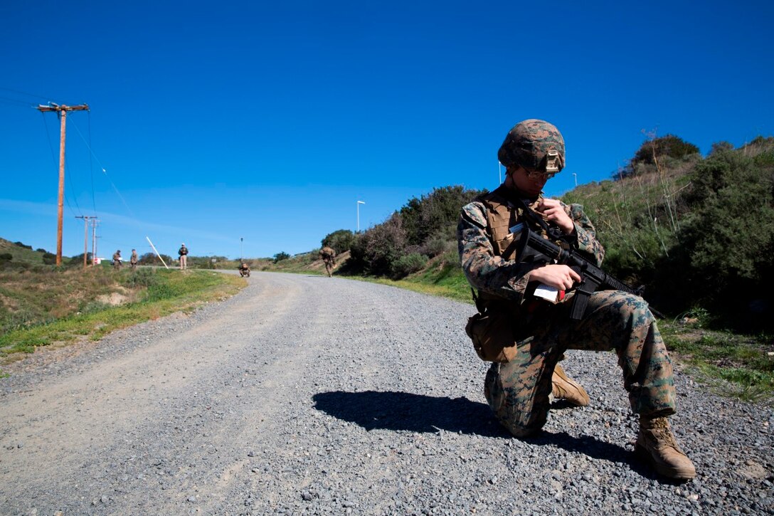 Lance Cpl. Janiel Gonzalez calls for a notional casualty evacuation during counter-IED training at Camp Pendleton, Feb. 12, 2016. This training is a new C-IED training curriculum developed by Marine Corps Engineer School, Defeat the Device Branch. Gonzalez is with Company A., 1st Combat Engineer Battalion, 1st Marine Division.