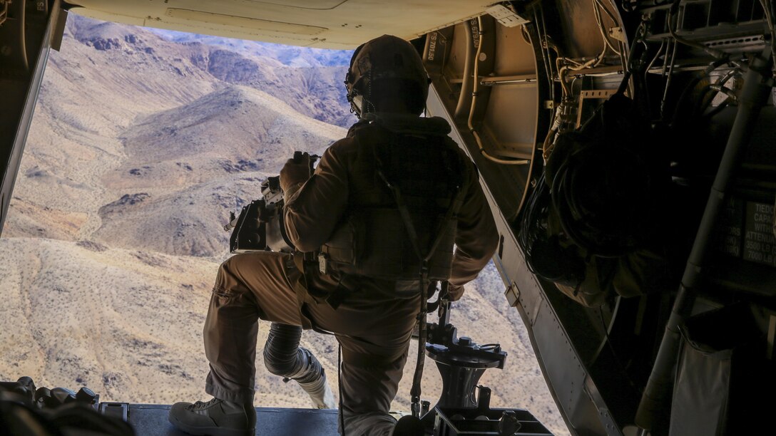 A Marine with Marine Medium Tiltrotor Squadron 363, 3rd Marine Aircraft Wing, provides security on an MV-22B Osprey as Marines and Sailors with Company F, 2nd Battalion, 7th Marine Regiment, 1st Marine Division, conduct a tactical recovery of aircraft and personnel training mission aboard Marine Corps Air Ground Combat Center Twentynine Palms, Calif., Feb. 4, 2016. The training will better prepare 2/7 and VMM-363 for their upcoming deployment to the Central Command area of responsibility as elements of Special Purpose Marine Air Ground Task Force Crisis Response Central Command 16.2, where they will be positioned to conduct TRAP missions in support of Operation Inherent Resolve. (U.S. Marine Corps photo by Cpl. Danielle Rodrigues/Released)