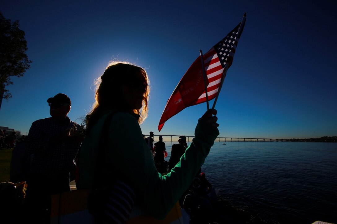 Shelley Mackey proudly displays the colors in honor of the Marines and sailors deploying with of the 13th Marine Expeditionary Unit, I Marine Expeditionary Force, in San Diego Feb. 12, 2016. Her son, Lance Cpl. Brett Mackey from Dallas, Ore., a rifleman, deployed with the 13th MEU as part of the Battalion Landing Team, 2nd Battalion, 1st Marine Regiment, I Marine Expeditionary Force. The 13th MEU is capable of conducting amphibious operations, crisis response and limited contingency operations and is beginning an estimated six-month deployment to the Western Pacific and Middle East. (U.S. Marine Corps photo by Lance Cpl. Caitlin Bevel)