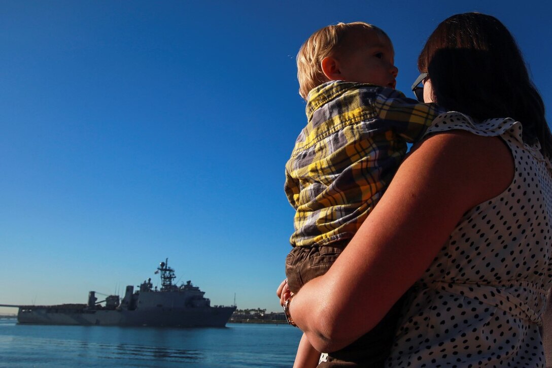 Ashley Mortensen and her son, Tanner, watch the approach of the USS Harpers Ferry during the departure of the 13th Marine Expeditionary Unit from Sand Diego Feb. 12, 2016. Her husband, 2nd Lt. Dale Mortensen from Seattle, a logistics officer, deployed with the 13th MEU as part of the Battalion Landing Team, 2nd Battalion, 1st Marine Regiment, I Marine Expeditionary Force. The 13th MEU is capable of conducting amphibious operations, crisis response and limited contingency operations and is beginning an estimated six month deployment to the Western Pacific and Middle East. (U.S. Marine Corps photo by Lance Cpl. Caitlin Bevel)
