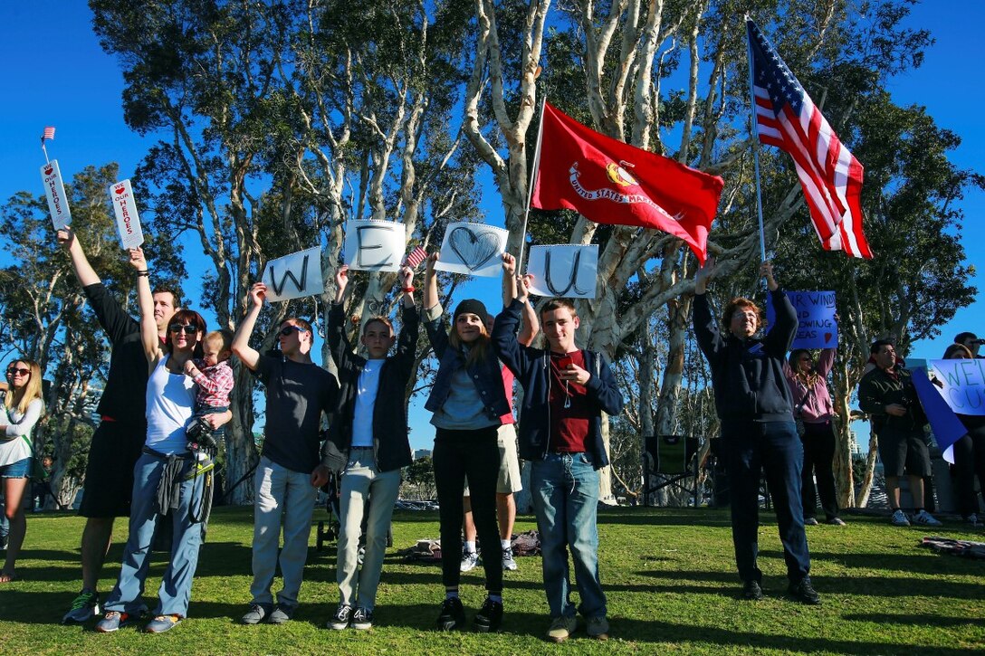 The family of Cpl. Scott Crook shows their support during the departure of the 13th Marine Expeditionary Unit from Sand Diego Feb. 12, 2016. Crook, from Temecula, a field artillery fire control man, deployed with the 13th MEU as part of the Battalion Landing Team, 2nd Battalion, 1st Marine Regiment, I Marine Expeditionary Force. The 13th MEU is capable of conducting amphibious operations, crisis response and limited contingency operations and is beginning an estimated six-month deployment to the Western Pacific and Middle East. (U.S. Marine Corps photo by Lance Cpl. Caitlin Bevel)