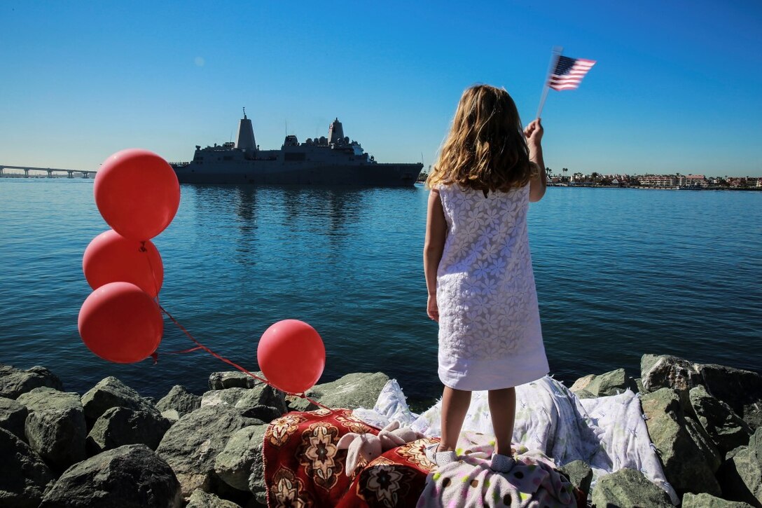 A Marine's daughter waves to the USS New Orleans where her father is departing with the 13th Marine Expeditionary Unit, I Marine Expeditionary Force, in San Diego Feb. 12, 2016. Her father is an infantry officer, deployed with the 13th MEU and is part of the Battalion Landing Team, 2nd Battalion, 1st Marine Regiment, I Marine Expeditionary Force. The 13th MEU is capable of conducting amphibious operations, crisis response and limited contingency operations and is beginning an estimated six-month deployment to the Western Pacific and Middle East. (U.S. Marine Corps photo by Lance Cpl. Caitlin Bevel)