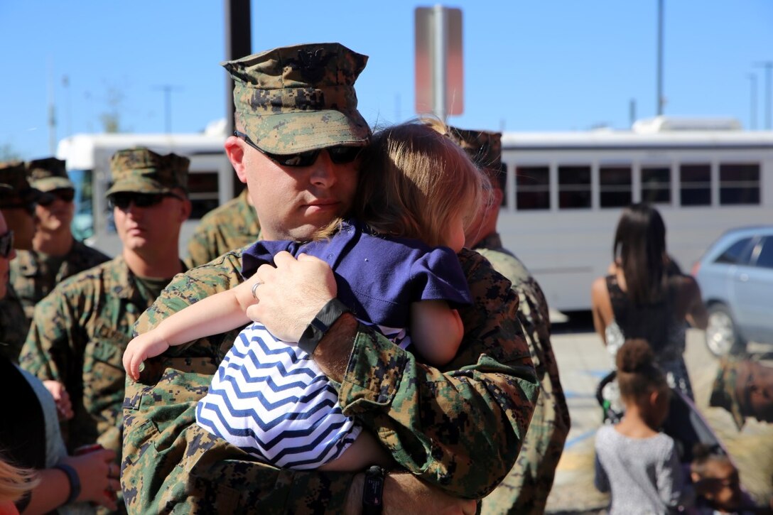 Petty Officer 1st Class Matthew Porzio, from Syracuse, New York, hugs his daughter on their last day together at Camp Pendleton Feb. 11, 2016. Matthew is a hospital corpsman with 1st Combat Logistics Regiment, deploying with the 13th Marine Expeditionary Unit to the Western Pacific and the Middle East. (U.S. Marine Corps photo by Cpl. John Baker)