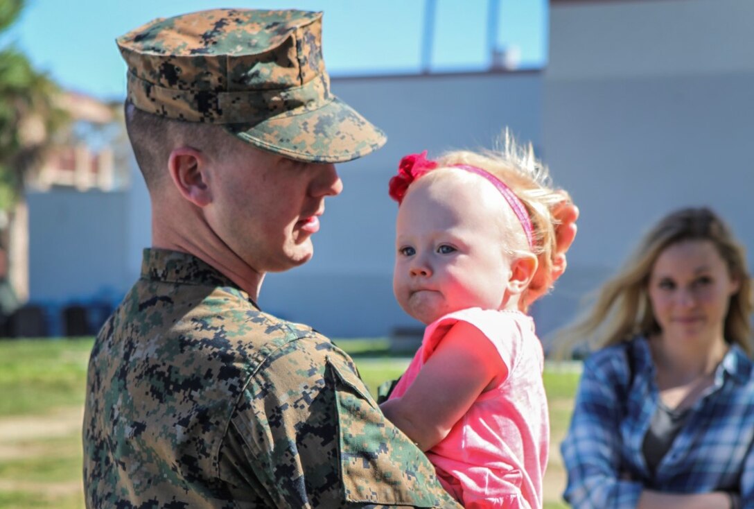 A Marine holds his daughter for the last time during a farewell gathering for the Marines and sailors of the 13th Marine Expeditionary Unit Feb. 11, 2016. Service members with 13th MEU are deploying as part of the Boxer Amphibious Ready Group to the Western Pacific and the Middle East. The gathering was held on Camp Pendleton. (U.S. Marine Corps photo by Sgt. Jessica Ostroska/Released)