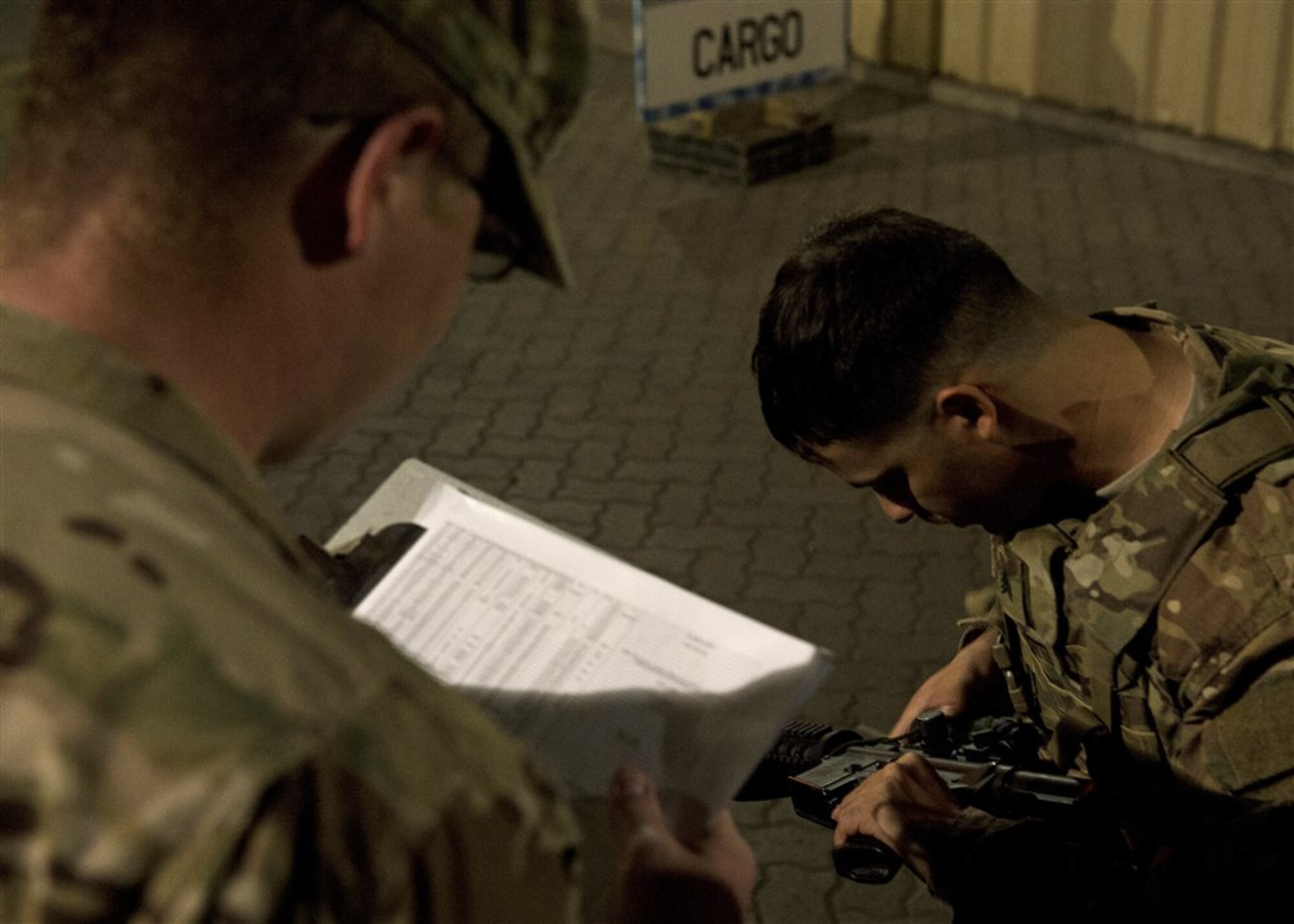 Soldiers from Bravo Company, 3rd Battalion, 15th Infantry Regiment, verify equipment information Feb. 13, 2016, at Camp Lemonnier, Djibouti. Members of Bravo Company participated in a two-part validation exercise that consisted of a rapid mobilization scenario from the camp, which lead to the company convoying to and providing simulated security for the U.S. Embassy in Djibouti. (U.S. Air Force photo by Senior Airman Peter Thompson)
