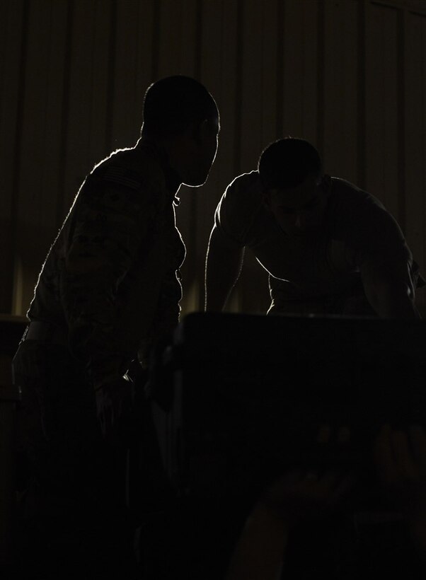 Soldiers from Bravo Company, 3rd Battalion, 15th Infantry Regiment, load pallets with water and meals ready-to-eat Feb. 13, 2016, at Camp Lemonnier, Djibouti. After being recalled in the early hours of the morning to validate the East Africa Response Force’s rapid response ability, EARF members gathered and immediately began by prepping personal gear and equipment. Shortly after, teams began building pallets with all the necessities for self-sustainment and mission accomplishment. (U.S. Air Force photo by Senior Airman Peter Thompson)