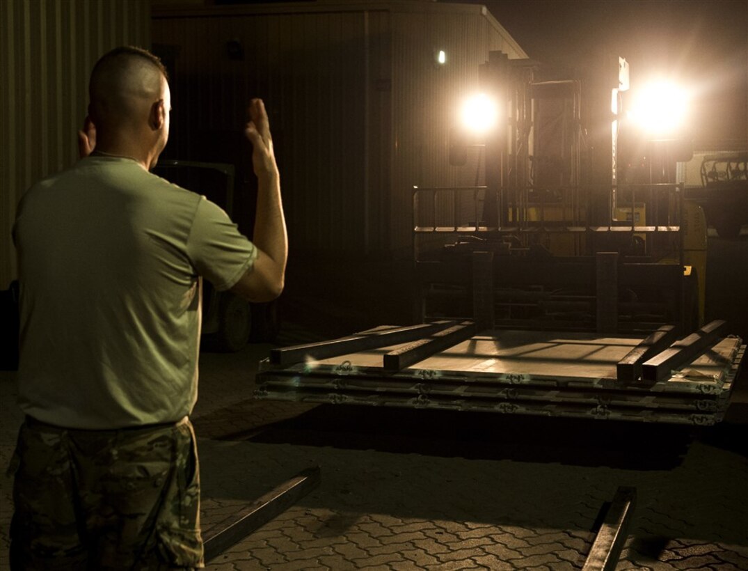A U.S. Army Soldier from Bravo Company, 3rd Battalion, 15th Infantry Regiment, directs a forklift Feb. 13, 2016, at Camp Lemonnier, Djibouti. After being recalled in the early hours of the morning to validate the East Africa Response Force’s rapid response ability, EARF members gathered and immediately began by prepping personal gear and equipment. Shortly after, teams began building pallets with all the necessities for self-sustainment and mission accomplishment. (U.S. Air Force photo by Senior Airman Peter Thompson)