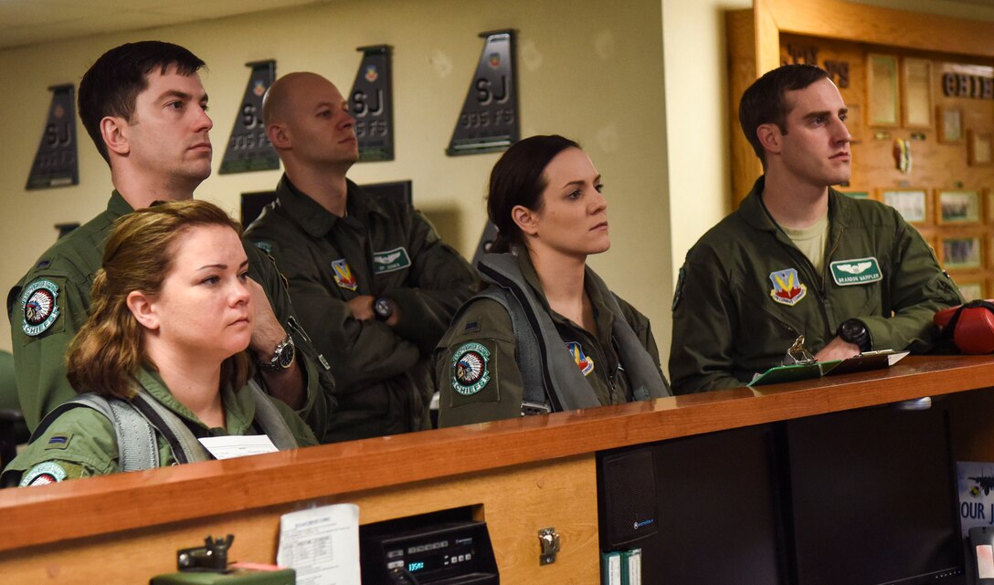 Aircrew and spouses from the 335th Fighter Squadron receive a briefing before heading to the flightline, Feb. 16, 2016, at Seymour Johnson Air Force Base, North Carolina. Spouses received a pre-flight briefing before heading to the flightline for taxi rides. (U.S. Air Force photo/Airman Shawna L. Keyes)

