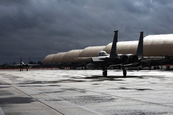 Two F-15E Strike Eagles taxi to the flightline, Feb. 16, 2016, at Seymour Johnson Air Force Base, North Carolina. More than 30 spouses from the 335th Fighter Squadron and 4th Aircraft Maintenance Squadron got the opportunity to see the aircraft up close and personal and received taxi rides around the runway. (U.S. Air Force/Airman Shawna L. Keyes)