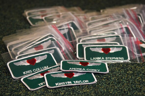 Spouses of members of the 335th Fighter Squadron and 4th Aircraft Maintenance Squadron received specialized name tags during a tour of the squadron, Feb. 16, 2015, at Seymour Johnson Air Force Base, North Carolina. During the tour, spouses donned flight gear and received a taxi ride in the F-15E Strike Eagle. (U.S. Air Force photo/Airman Shawna L. Keyes)