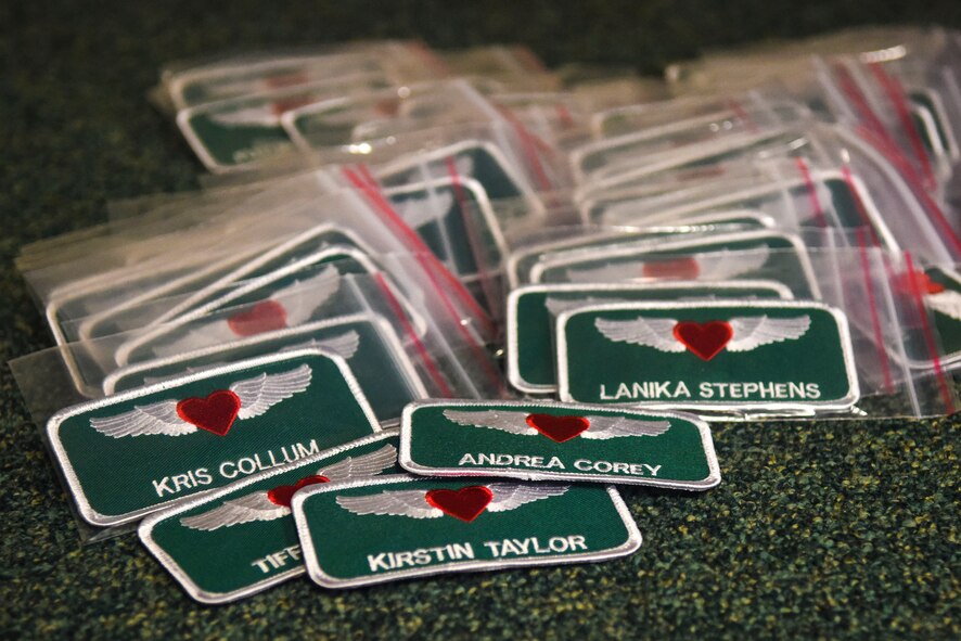 Spouses of members of the 335th Fighter Squadron and 4th Aircraft Maintenance Squadron received specialized name tags during a tour of the squadron, Feb. 16, 2015, at Seymour Johnson Air Force Base, North Carolina. During the tour, spouses donned flight gear and received a taxi ride in the F-15E Strike Eagle. (U.S. Air Force photo/Airman Shawna L. Keyes)