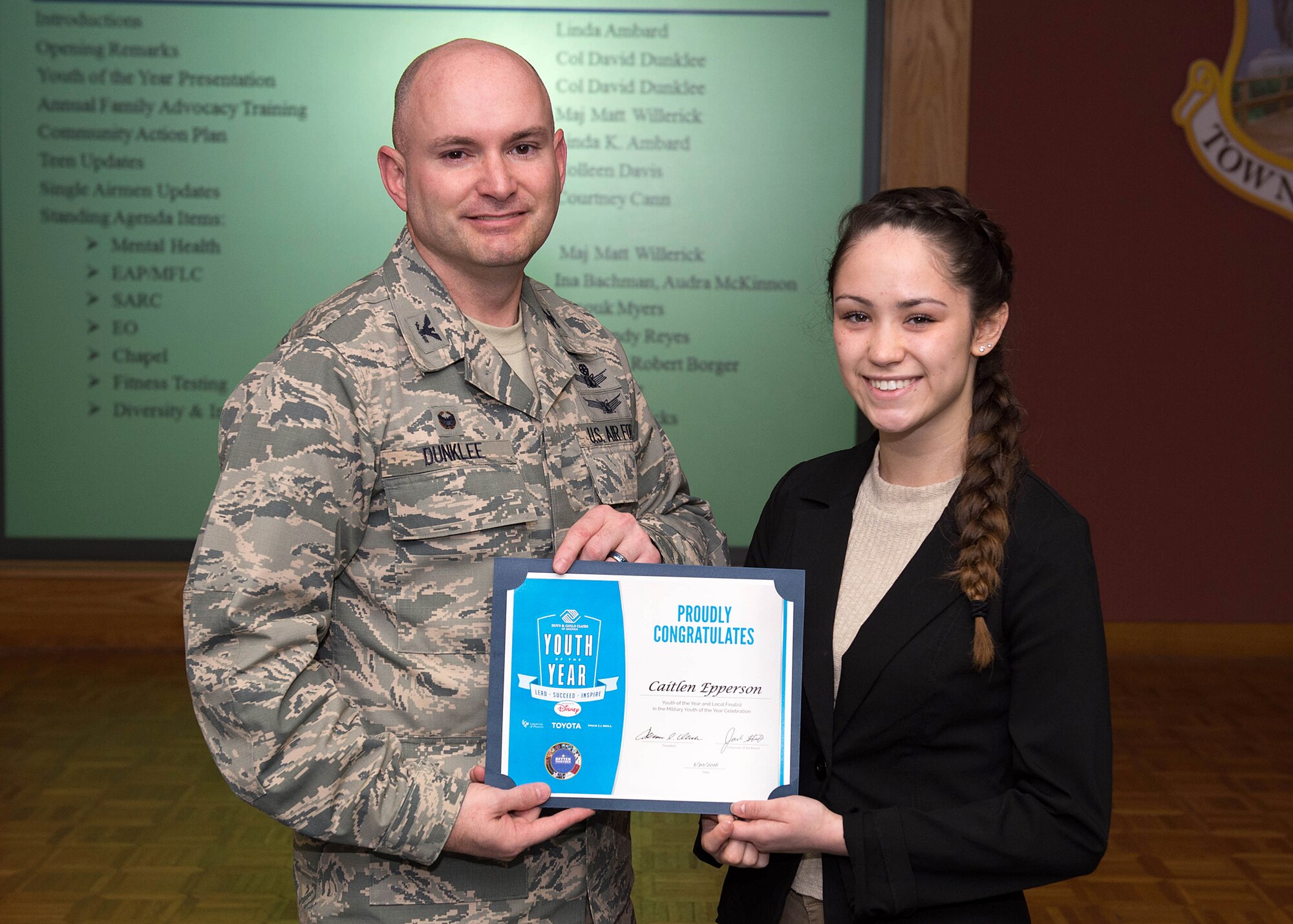Col. David R. Dunklee, installation commander, presents Caitlen Epperson a certificate during the Community Action Information Board meeting Feb. 18 in recognition of her being named Hanscom's Youth of the Year. Epperson, an 18 year-old senior at Bedford High School, will now move on to compete at the state level. (U.S. Air Force photo by Jerry Saslav)