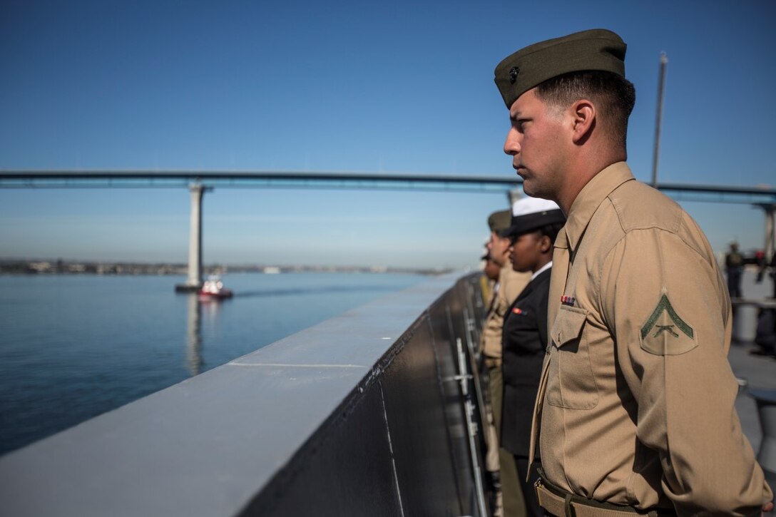 U.S. Marines and Sailors with the 13th Marine Expeditionary Unit man the rails aboard the USS New Orleans as they depart San Diego, California, February 12, 2016. The Boxer Amphibious Ready Group and the 13th MEU will be operating in the Pacific and central Commands area of responsibilities during their western pacific deployment 16-1. (U.S. Marine Corps photo by Sgt. Tyler C. Gregory/released)