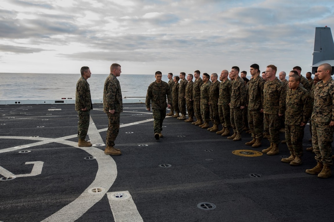 U.S. Navy Hospital Corpsman 3rd Class Nicolas Biscocho with Combat Logistics Battalion 13, Boxer Amphibious Ready Group/13th Marine Expeditionary Unit receives an Enlisted Fleet Marine Force Warfare Specialist Qualification device during a formation aboard the USS New Orleans, February 16, 2016. The device signifies the completion of the Fleet Marine Force Qualification training that Navy Corpsmen take to familiarize themselves with the Marine Corps. (U.S. Marine Corps photo by Sgt. Tyler C. Gregory/released)