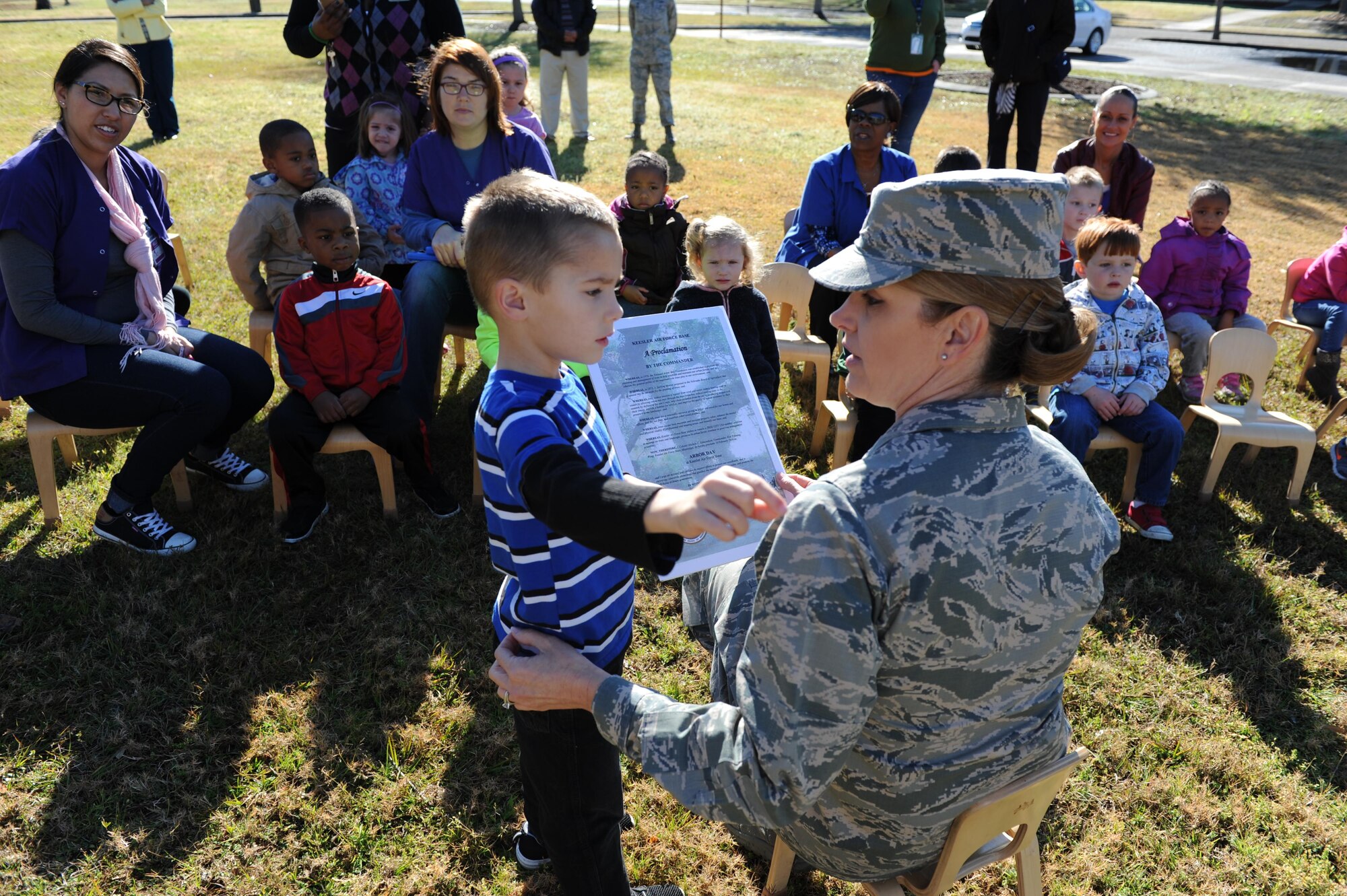 Col. Michele Edmondson, 81st Training Wing commander, receives help from Brody Wheeler, son of Staff Sgt. James Wheeler, 335th Training Squadron instructor, with reading an Arbor Day Proclamation during an Arbor Day celebration outside of the child development center Feb. 16, 2016, Keesler Air Force Base, Miss. Children from the child development center assisted with a live oak tree planting ceremony. (U.S. Air Force photo by Kemberly Groue)