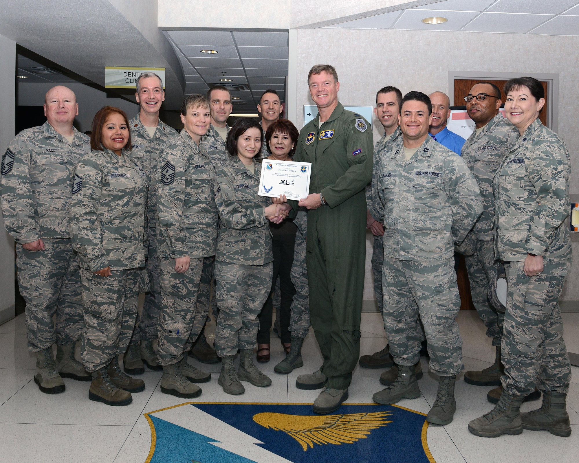 Airman 1st Class Maritza Caldera, center, 47th Medical Operations Squadron mental health technician, accepts the “XLer of the Week” award from Col. Thomas Shank, right, 47th Flying Training Wing commander, and Chief Master Sgt. Teresa Clapper, left, 47th FTW command chief, here, Feb. 17, 2016. The XLer is a weekly award chosen by wing leadership and is presented to those who consistently make outstanding contributions to their unit and Laughlin. (U.S. Air Force photo by Senior Airman Jimmie D. Pike)