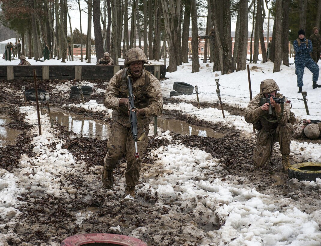Candidates assigned to Delta Company, Officer Candidates Class-221, work together to complete the Buddy Team Fire and Movement Course at Brown Field, Marine Corps Base Quantico, Va., on Jan. 28, 2016. The mission of Officer Candidates School (OCS) is to "educate and train officer candidates in Marine Corps knowledge and skills within a controlled, challenging, and chaotic environment in order to evaluate and screen individuals for the leadership, moral, mental, and physical qualities required for commissioning as a Marine Corps officer." (U.S. Marine Corps Photo by Cpl. Patrick H. Owens/Released)