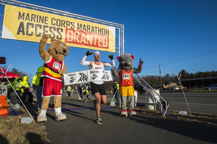Jimmy Sosinski runs passed the finish line of  the Marine Corps 17.75k in Prince William County, Va., on March 28, 2015. Sosinski finishes in first place for the males and first place overall, finsihing the 11 mile trek in one hour, six minutes and five seconds. (U.S. Marine Corps Photo by Lance Cpl. Jacqueline A. Garcia/ Released) 