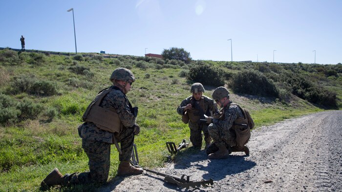 U.S. Marines call in for Explosive Ordnance Disposal technicians after discovering a possible IED during counter-IED training at Marine Corps Base Camp Pendleton, Feb. 12, 2016. The Marines were testing out the pilot course of Marine Corps Engineer School, Defeat the Device branch, Counter-IED Training Class. The Marines participating in the training are with Company A, 1st Combat Engineer Battalion, 1st Marine Division.