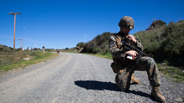 Lance Cpl. Janiel Gonzalez calls for a notional casualty evacuation during counter-IED training at Marine Corps Base Camp Pendleton, Feb. 12, 2016. This training is a new C-IED training curriculum developed by Marine Corps Engineer School, Defeat the Device Branch. Gonzalez is with Company A., 1st Combat Engineer Battalion, 1st Marine Division.