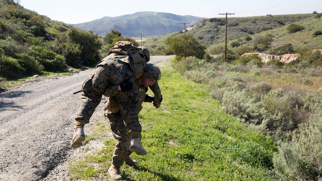 Lance Cpl. Brandon Larue carries Cpl. Estelito Manansala a notional casualty during a counter-IED training exercise at Marine Corps Base Camp Pendleton, Feb. 12, 2016. This training is a part of a new Counter-IED Training Class developed by the Marine Corps Engineer School, Defeat the Device Branch, to improve operational readiness. Larue and Manansala are with Company A., 1st Combat Engineer Battalion, 1st Marine Division.
