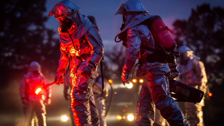 Marines prepare to light the fire during a controlled burn training exercise aboard Marine Corps Air Station Beaufort Feb. 17. The exercise utilized burning jet fuel around a model jet to give Marines a realistic experience of putting out an aircraft fire. The Marines are with Aircraft Rescue and Firefighting. 