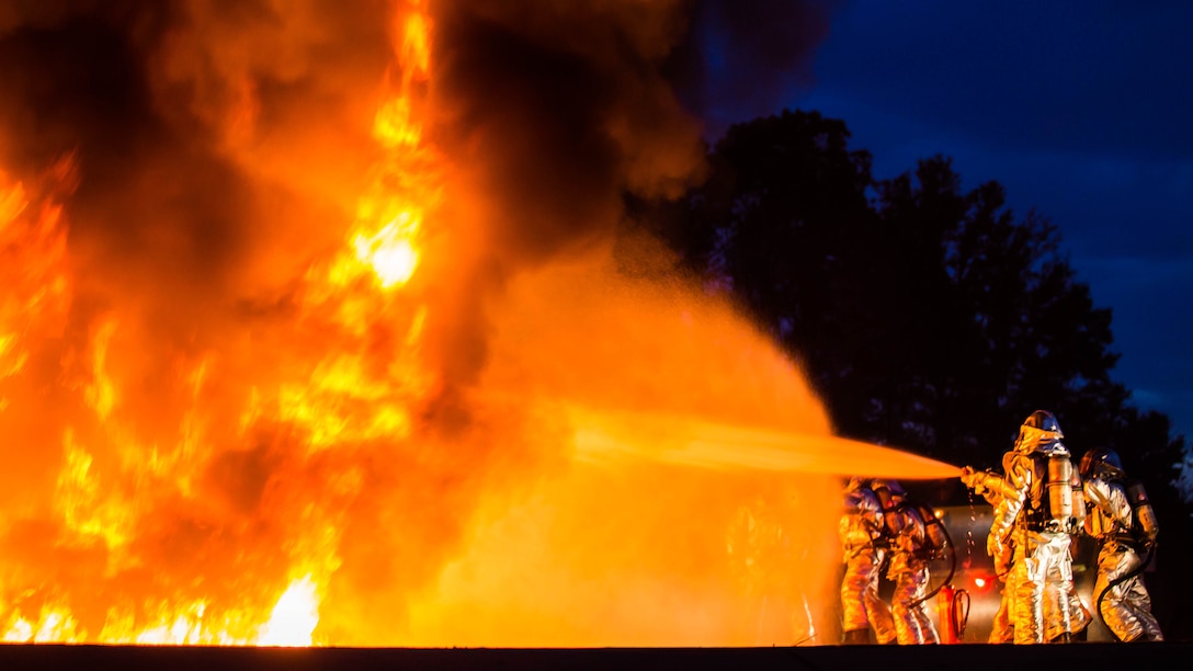 Marines extinguish a fire during a controlled burn training exercise aboard Marine Corps Air Station Beaufort Feb. 17. The Marines battling the blaze use hoses to push the fire away from the model jet’s cockpit to simulate procedure for rescuing the pilot in a real life scenario. The Marines are with Aircraft Rescue and Firefighting. 