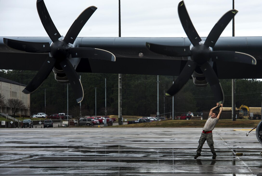 Air Force Senior Airman Thomas Budd turns a propeller on a C-130J Super Hercules aircraft on Pope Army Airfield, N.C., Feb. 4, 2016. Budd is a crew chief assigned to the 19th Aircraft Maintenance Squadron. Air Force photo by Staff Sgt. Marianique Santos