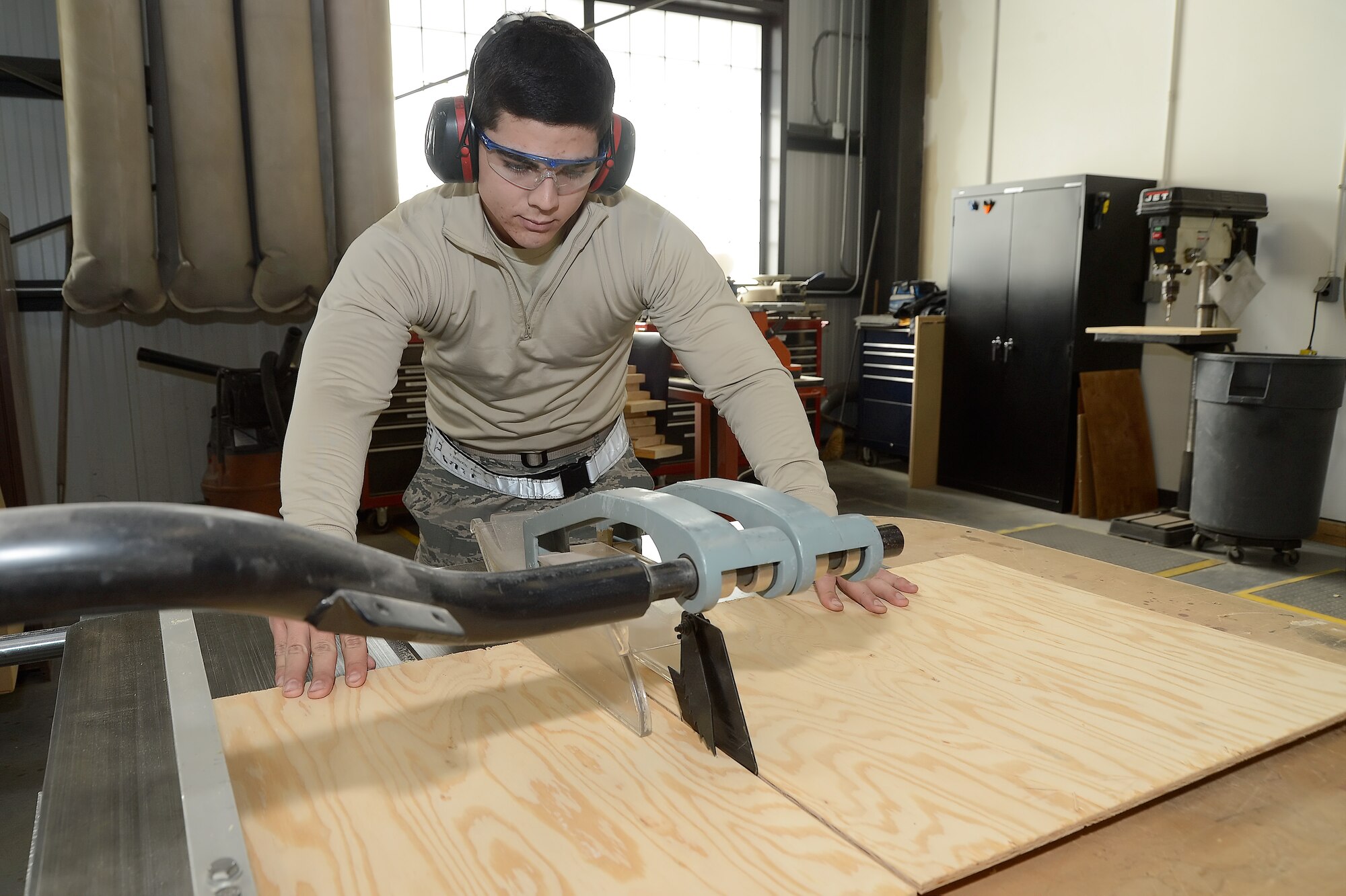 Airman 1st Class Yasel Berrocal, 436th Aerial Port Squadron packing and crating clerk, uses a table-saw to cut down plywood for a crate being built to transport a C-5M Super Galaxy wing-flap Feb. 10, 2016, at Dover Air Force Base, Del. The packing and crating section within APS makes custom crates for shipping high-value items such as aircraft components. They also make custom boxes using a machine that saves the Air Force thousands of dollars per year versus buying pre-made boxes. (U.S. Air Force photo/Greg L. Davis)