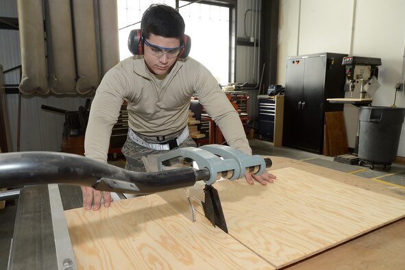 Airman 1st Class Yasel Berrocal, 436th Aerial Port Squadron packing and crating clerk, uses a table-saw to cut down plywood for a crate being built to transport a C-5M Super Galaxy wing-flap Feb. 10, 2016, at Dover Air Force Base, Del. The packing and crating section within APS makes custom crates for shipping high-value items such as aircraft components. They also make custom boxes using a machine that saves the Air Force thousands of dollars per year versus buying pre-made boxes. (U.S. Air Force photo/Greg L. Davis)