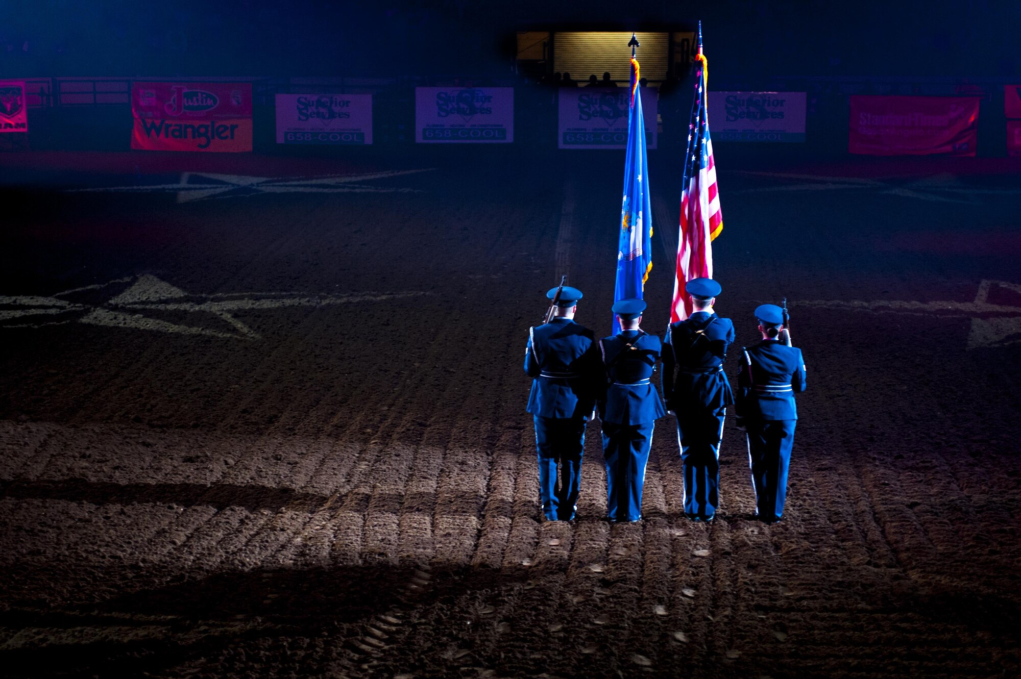 Goodfellow Air Force Base Honor Guard presents the colors during the San Angelo Stock Show and Rodeo Military Appreciation Night at the Foster Communications Coliseum, San Angelo, Texas, Feb. 17, 2016. The "Star Spangled Banner" was sung during the presenting of the colors, serving as the ceremonial opener for the event. (U.S. Air Force photo by Senior Airman Scott Jackson/Released)