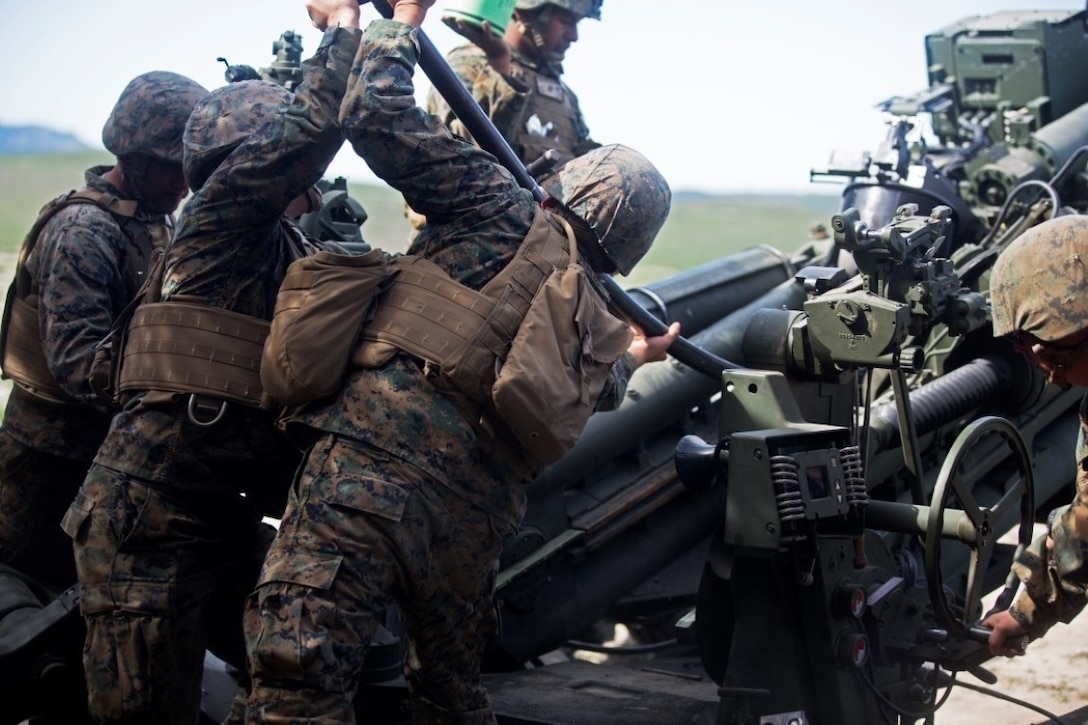 Marines work together to load a 155mm round into the M777 Howitzer cannon during a battery-level fire exercise at Camp Pendleton, Calif., Feb. 10, 2016. The battery participated in a fire exercise in preparation for their upcoming deployment with the 31st Marine Expeditionary Unit. This exercise was the first time the battery used the Digital Firing Control system, a computer that shows grid coordinates of targets and accompanying information. This system is important because it provides a faster response time than using iron sights to fire the howitzer. The Marines are with Battery F, 2nd Battalion, 11th Marine Regiment, 1st Marine Division. (U.S. Marine Corps Photo by Lance Cpl. Justin E. Bowles)