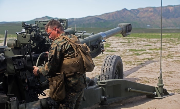 Sgt. Kenneth A. Ashcraft references coordinates from the Digital Firing Control System and calibrates the direction of the M777 Howitzer cannon during a battery-level fire exercise at Camp Pendleton, Calif., Feb. 10, 2016. Marines performed fire exercises in preparation for their upcoming deployment with the 31st Marine Expeditionary Unit. This exercise was the first time the battery used the DFCS, a computer that shows grid coordinates of targets and accompanying information. This system is important because it provides a faster response time than using iron sights to fire the howitzer. Ashcraft, from Tyler, Texas, is a field artillery cannoneer with Battery F, 2nd Battalion, 11th Marine Regiment, 1st Marine Division. (U.S. Marine Corps Photo by Lance Cpl. Justin E. Bowles)