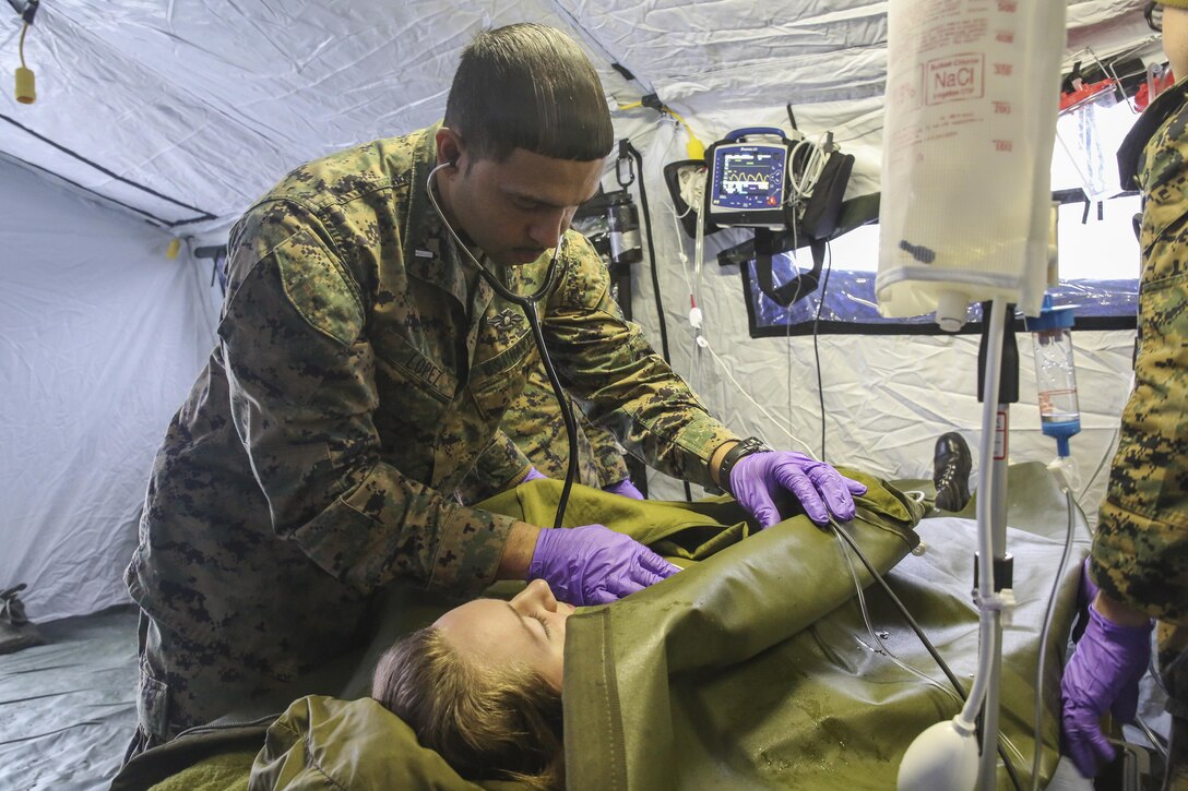 Lt. j.g. Eric Lopez, a physician assistant with the 2nd Marine Expeditionary Brigade, checks the heart rate of a notional Norwegian soldier casualty during combat casualty care training in Rena, Norway, Feb. 17, 2016. More than ten Marines and sailors with the unit conducted simulated medical treatment onto their Norwegian counterparts in order to enhance and compare their field medical care capabilities. The two countries are coming together for Exercise Cold Response 16 in March, which combines the efforts of 12 NATO allies and partner nations to enhance joint crisis response capabilities in cold weather environments. (U.S. Marine Corps photo by Cpl. Lucas Hopkins/Released)