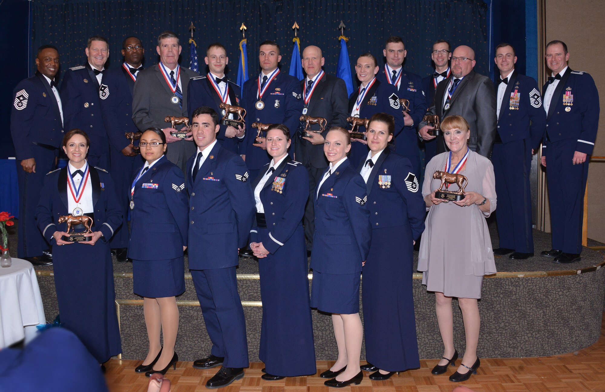 Chief Master Sgt. Calvin Williams (top row, left), command chief for the Air Force Global Strike Command, and Gen. Robin Rand, AFGSC commander, joined Col. Eric Froehlich (top row, right), 377th Air Base Wing commander, in congratulating the wing's annual award winners at an awards ceremony Feb. 5 at the Mountain View Club. (Photo by Ken Moore) 
