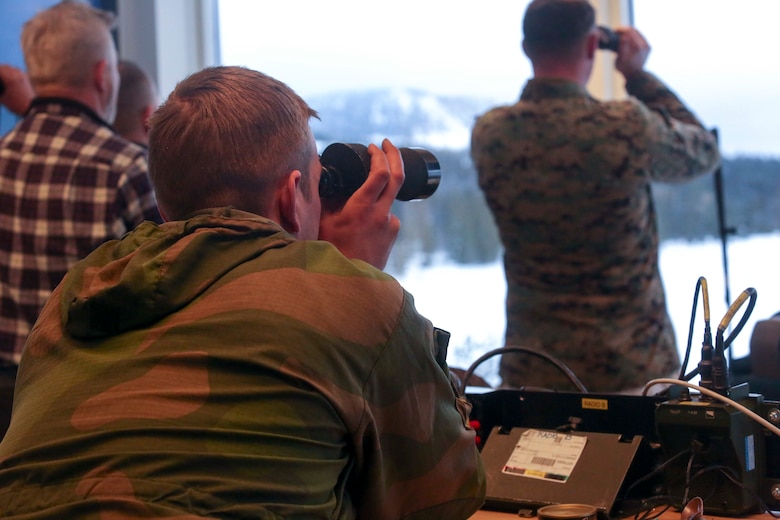 A member of the Norwegian Army looks at the down range area as U.S. Marines conduct a live-fire exercise in Rena, Norway, Feb. 17, 2016. The Marines are preparing themselves for Exercise Cold Response 16, which will bring together 12 NATO allies and partner nations and approximately 16,000 troops in order to enhance joint crisis response capabilities in cold weather environments. (U.S. Marine Corps photo by Cpl. Dalton A. Precht/released)