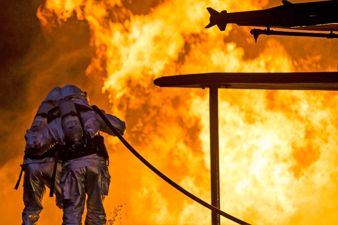 Marines extinguish a fire during a controlled burn training exercise on Marine Corps Air Station Beaufort, S.C., Feb. 17, 2016. The Marines, assigned to Aircraft Rescue and Firefighting, train to respond to an emergency within three minutes. Marine Corps photo by Lance Cpl. Jonah Lovy
