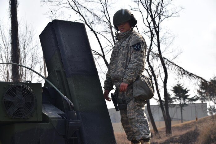 Pvt. Imaris Suarez stands atop a AN/TWQ-1 Avenger Missile System during a readiness drill at Osan Air Base, South Korea, Feb. 16. 2016. Suarez, an air defense battle management system operator assigned to E Battery, 6th Battalion, 52nd Air Defense Artillery Regiment from Ware, Mass., is learning how Patriot and Avenger systems work to provide layered air and missile defense on the Korean peninsula. (Photo by U.S. Army Capt. William Leasure, 35th ADA Brigade Public Affairs)