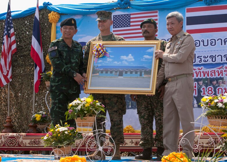Left to right: Royal Thai Army Gen. Wichien Sirisoonthorn, Royal Thai Armed Forces Headquarters; U.S. Marine Corps Brig. Gen. Russell Sanborn, commanding general of 1st Marine Aircraft Wing, III Marine Expeditionary Force; Malaysian Army Lt. Col. Made Trika, Malaysian Armed Forces; Mr. Channa Eiumsang, governor of Trat Province. The distinguished hold a photo of the one-room multi-purpose educational building that was dedicated Feb. 18 at Ban Sa Yai, Trat, Thailand. The construction at Ban Sa Yai was one of six humanitarian civic action sites in which the Thai, U.S. and partner nation’s militaries will worked together on civic programs during Cobra Gold 2016. Cobra Gold, in its 35th iteration, demonstrates the commitment of the Kingdom of Thailand and the U.S. to our long-standing alliance and regional partnership toward advancing prosperity and security in the Indo-Asia Pacific region.  (U.S. Marine Corps photo by SSgt. Jose O. Nava/Released)